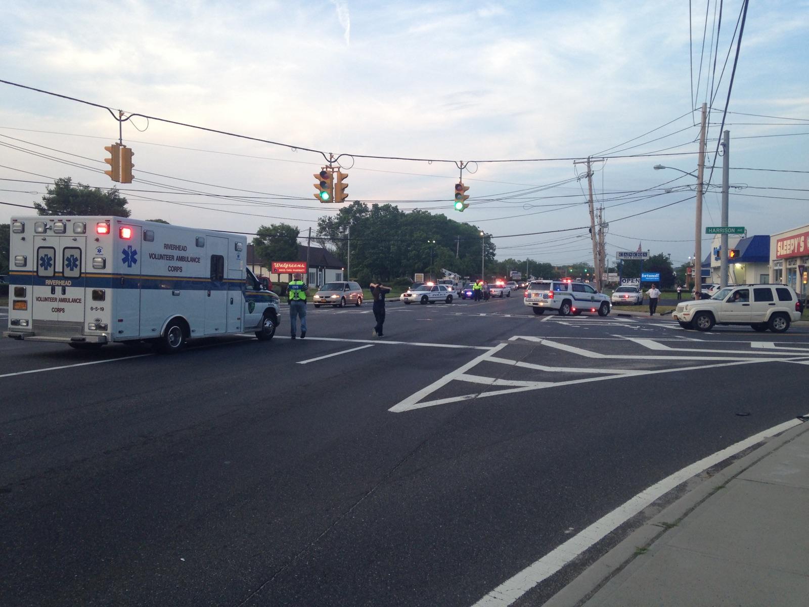 Riverhead police and fire officials at the scene on Route 58 on Monday. (Credit: Nicole Smith)