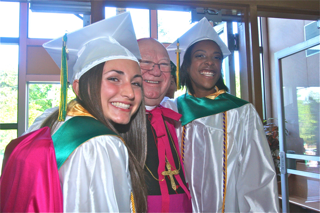 Meghan Bossone (left) and Adafih Blackburn (right) pose for a photo with Bishop William Murphy. (Credit: Barbaraellen Koch)