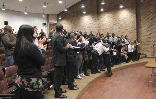 PAUL SQUIRE PHOTO | Demitri Hampton's friends and family give a standing ovation for his mother, Juanita Trent, during Monday's memorial service.