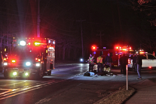 PAUL SQUIRE PHOTO | Wading River Fire Department volunteers stand near debris at the scene of  Thursday night's crash. 