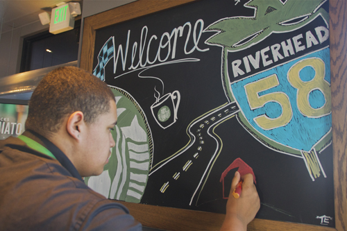 Tom Edler from Riverhead finishes up a chalkboard drawing at the Starbucks on Route 58. (Credit: Paul Squire)