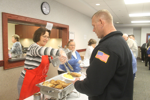 PAUL SQUIRE PHOTO | Barbara from the Ladies Auxiliary doles out french toast at Sunday's breakfast fundraiser.