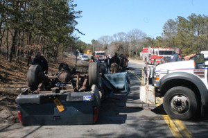 PAUL SQUIRE PHOTO | Suffolk County police emergency teams work to flip the wreck over Tuesday afternoon.