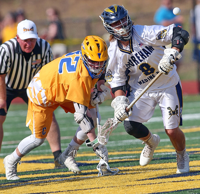 Shoreham-Wading River's Joe Miller (right) on the face-off for the WIldcats. (Credit: Garret Meade)