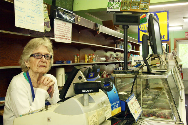 Juanita Devlin behind the cash register at her store Thursday morning. (Credit: Barbaraellen Koch)