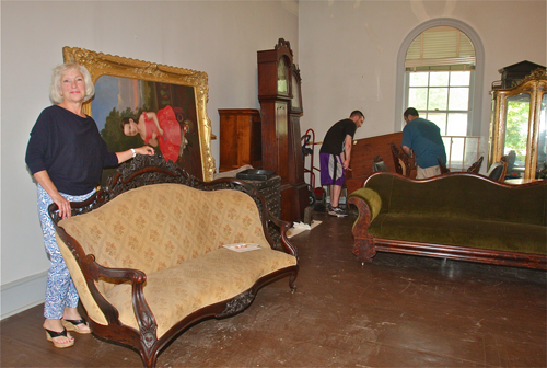 Suffolk County Historical Society executive director Kathy Curran in the organization's East Wing Gallery Thursday.  Workers are moving furniture and artwork into storage while the space is restored. (Credit: Barbaraellen Koch)