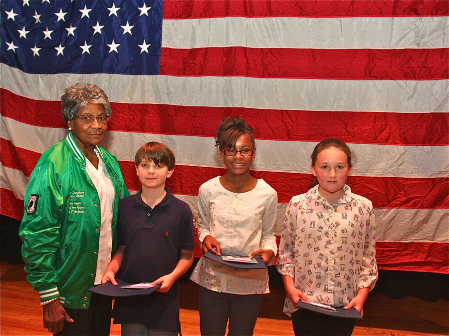 Medal of Honor recipient Pfc. Garfield M. Langhorn's mother, Mary Langhorn, with this year's sixth grade essay contest winners (from left) Christopher Donnelly, Alisha Griffin and Reilly Hubbard. (Credit: Barbaraellen Koch)