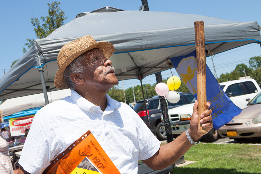 "Harry of Riverhead" tries out a rain stick from a display provided by the Southold Indian Museum. (Credit: Katharine Schroeder) 