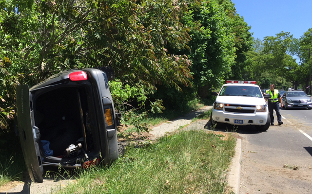 The driver of this overturned vehicle on Route 25 escaped serious harm Saturday afternoon. (Credit: Paul Squire)