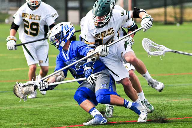 Riverhead's Mark Andrejack tries to elude the Ward Melville defender in Friday's playoff game. (Credit: Bill Landon)