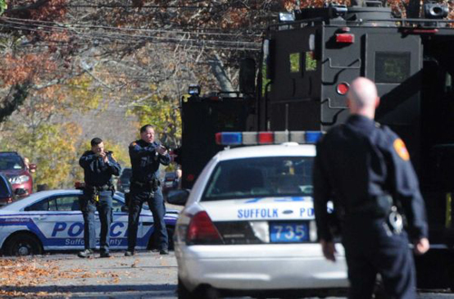 A nearly two-hour barricade in a Mastic house ended with three people coming out with hands up Wednesday, Nov. 19, 2014 in front of police with machine guns and armored vehicles. (Credit: James Carbone/Newsday)