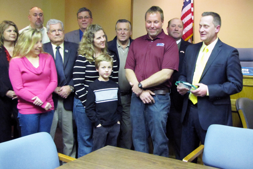Highway Department maintenance mechanic Michael Zaleski, second from right, was presented with Riverhead Town's 2013 Employee of the Year award at the Feb. 19, 2013 Town Board meeting.  His wife, Kim, and son Ryan are pictured beside him. (Credit: Tim Gannnon)
