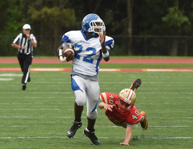 Riverhead junior William Mitchell eludes a final tackler on an 81-yard kickoff return for a touchdown Wednesday against Hills West. (Credit: Robert O'Rourk)