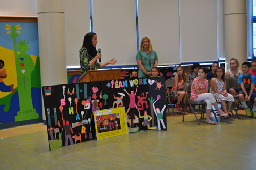 Joyce Raimondo, left, and art teacher Melissa Haupt talk about the mural with students during Thursday's ceremony. (Credit: Rachel Young)
