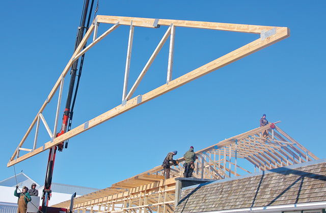 Workers with Shirk Construction of Pennslyvania putting up trusses on the addition to the Long Island Cauliflower building on Marcy Avenue in Polish Town in January. (Credit: Barbaraellen Koch)