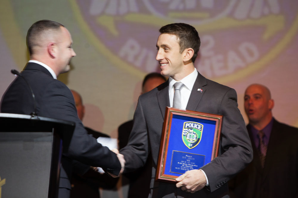 Officer John Morris presents the Cop of the Year award to Officer Daniel Hogan. (Credit: Katharine Schroeder)