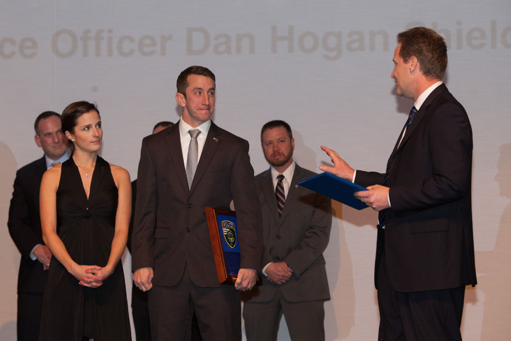 Town Supervisor Sean Walter presents a special proclamation to Officer Daniel Hogan. (Credit: Katharine Schroeder)