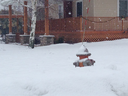 PAUL SQUIRE PHOTO | A fire hydrant in Calverton half-buried in the snow Tuesday morning.