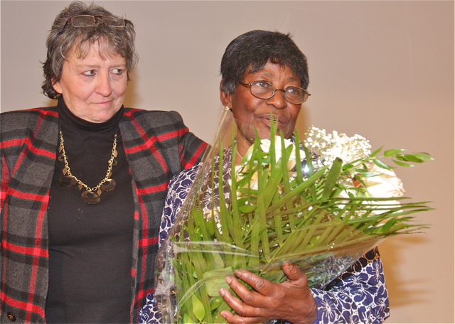 Library's patron services coordinator Liz Stokes giving a bouquet to Photo Show chairperson Thelma Booker.