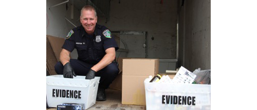 Riverhead Police Officer Rick Anderson weighing and packaging 102 pounds of drugs collected at the Take-Back Drive-Through event. (Credit: Courtesy)