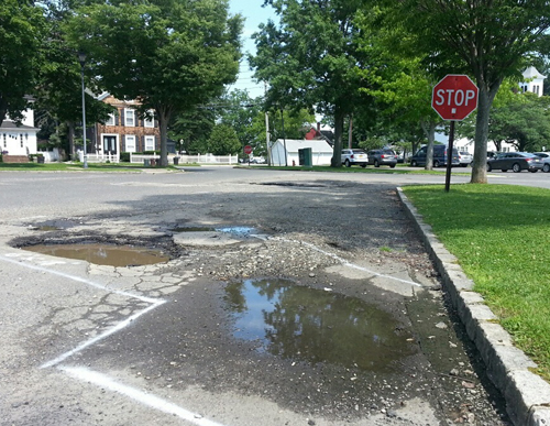These potholes are just a couple of close to 60 that will be fixed in a downtown parking lot. (Credit: Jen Nuzzo)