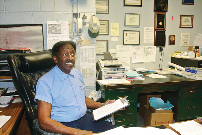 Carl James in his office last year at Pulaski Street School in Riverhead. Mr. James, 79, retired in June after working in the building for nearly 54 years as a custodian. (Credit: Barbaraellen Koch, file)