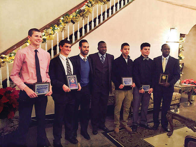 Members of the Riverhead High School boys soccer team showed off their awards at the awards dinner in Holbrook. From the left, goalkeeper Ryan DiResta (all-conference), defender Noah Markewitz (academic all-county), varsity coach Andrew Aleksandrowicz, varsity coach Lamine Traore, defender Ever Bonilla (all-conference), forward Anthony Antunes (all-league) and junior varsity coach Moussa Keita (junior varsity coach of the year). (Credit: Courtesy)