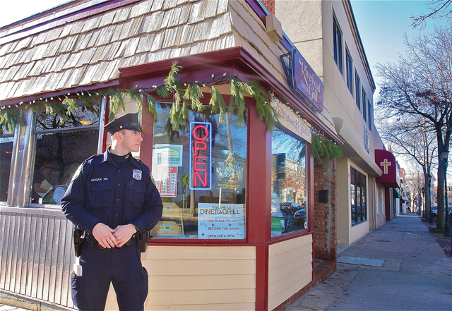 Officer Dan Hogan on patrol on East Main Street in downtown Riverhead. (Credit: Barbaraellen Koch)