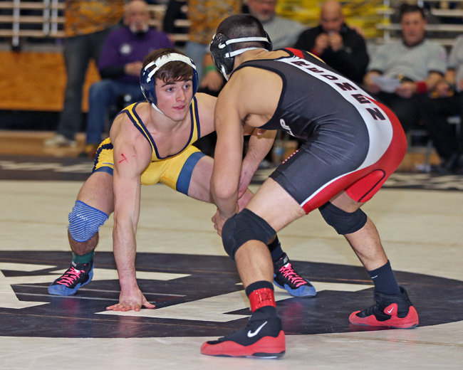 Shoreham-Wading River senior James Szymanski (yellow singlet) will wrestle for the first time in the state tournament after receiving an at-large bid this week. (Credit: Daniel De Mato)