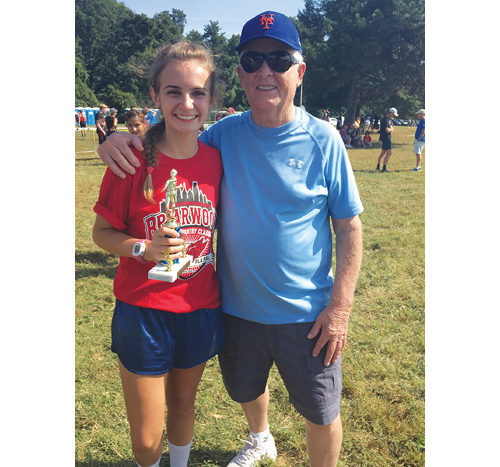 Caleigh and her grandfather, Curt Davis, after a cross country race earlier this year. (Courtesy photo)