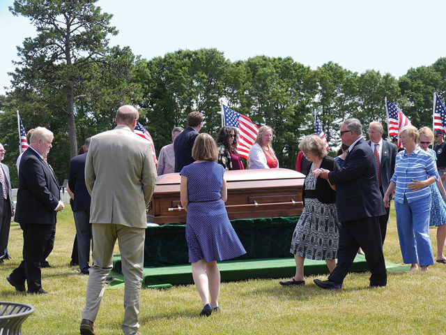 Family and friends circle the casket of U.S. Marine John Prince during his funeral Friday.  (Credit: Krysten Massa)