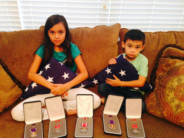 Alexa, 10, and Jace Venetz, 6, with medals awarded to their father Anthony Venetz Jr. of Wading River. (Credit: Debbie Venetz, courtesy)