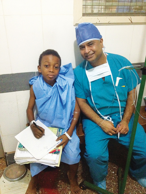 Dr. Patel in 2012 with a 12-year-old boy from Ghana whose enlarged spleen weighed as much as a newborn baby. (Courtesy photo)