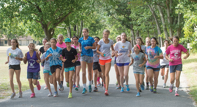 The Riverhead girls cross country team prepares for the season at practice last week. (Credit: Robert O'Rourk)