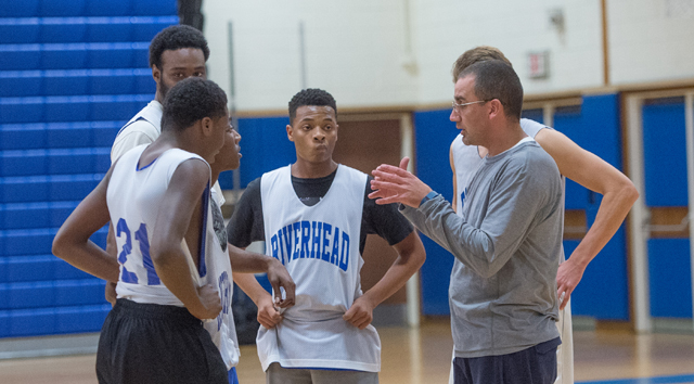 Riverhead coach John Rossetti goes over instructions at practice with several players last week. (Credit: Robert O'Rourk)