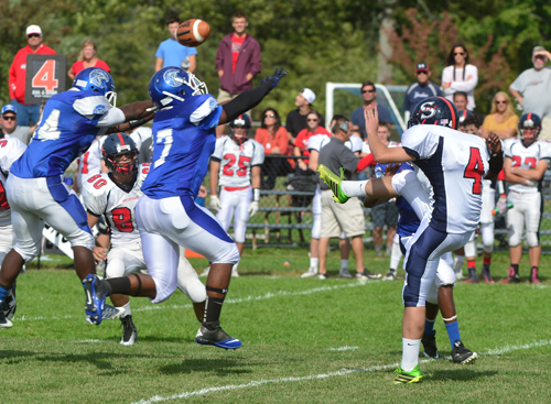 The Riverhead defense, led by Troy Trent, blocks the Smithtown East punt, which led to a Riverhead field goal before the second quarter expired. (Credit: Robert O'Rourk)