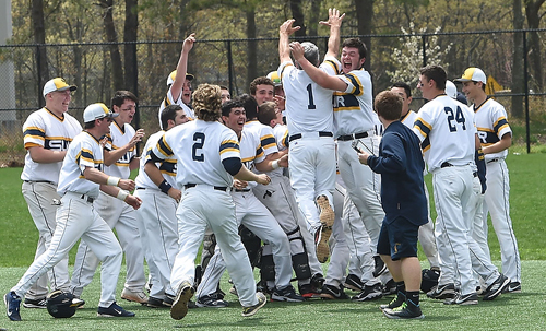 The Shoreham-Wading River Wildcats joined in celebration after defeating Bayport-Blue Point, 3-2, in extra innings and securing the League VII championship outright. (Credit: Robert O'Rourk)