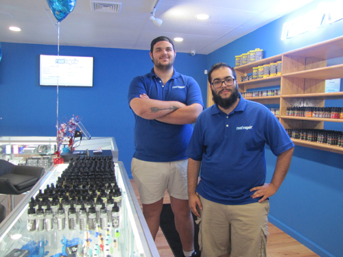 Employees Sam Leibowitz and Phil Brito inside Real Vapor, Riverhead's first e-cigarette store, on Route 58