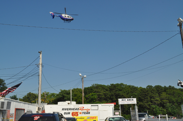 A police helicopter takes off for Stony Brook University Hospital from the track at Riverhed Raceway. (Credit: Grant Parpan)