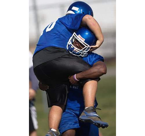 Raheem Brown gives a teammate a lift during practice. Coach Leif Shay said the 5-foot-9, 180-pound Brown is, pound for pound, one of the strongest players he has ever coached.