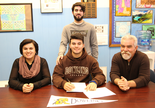 Riverhead senior forward Anthony Antunes signed a national letter of intent to play for Dowling College. Joining him in the signing ceremony on Tuesday were his parents Rosa and Jose and his brother Kevin. (Credit: Sandra Kolbo, courtesy)