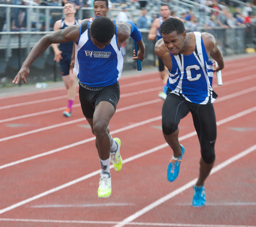 Riverhead's Steven Reid, left, leans forward at the finish line to nip a Copiague runner for victory in the 4x100-meter relay. (Credit: Robert O'Rourk)