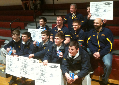 Shoreham-Wading River wrestlers and coaches posed for photos after the Wildcats saw all five of their league finalists claim championships. (Credit: Bob Liepa)