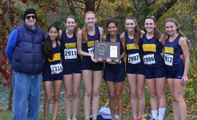 The Class B county champion Shoreham-Wading River girls cross country team. Pictured are (from left) coach Paul Koretzki, Francesca Lilly, Kaitlyn Ohrtman, Alexandra Hays, Katherine Lee, Amanda Dwyer, Payton Capes-Davis and Lexie Smith. (Credit: Robert O'Rourk)