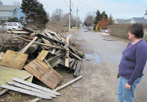 TIM GANNON PHOTO  |  A giant pile of superstorm Sandy debris has sat in front of Sheila Ganetis' Morningside Avenue home in Jamesport for almost two months. Town officials say she'll need to pay to get the junk removed.