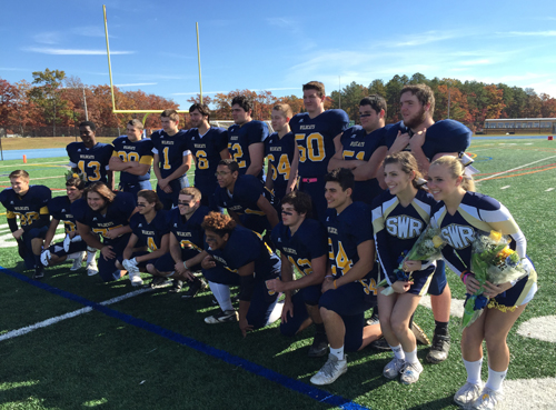Shoreham-Wading River's 19 senior football players and two senior cheerleaders participated in a pregame senior day ceremony. (Credit: Bob Liepa)