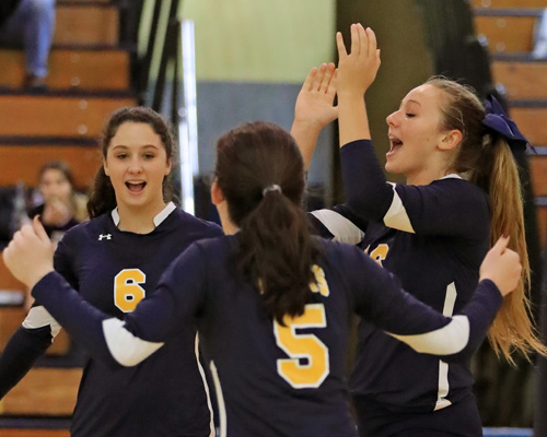 Courtney Wrigley #16 (right) celebrates a point with her teammates during the second set of Shoreham Wading River's three set loss to Sayville at Shoreham Wading River High School in Shoreham on Oct. 27, 2016.