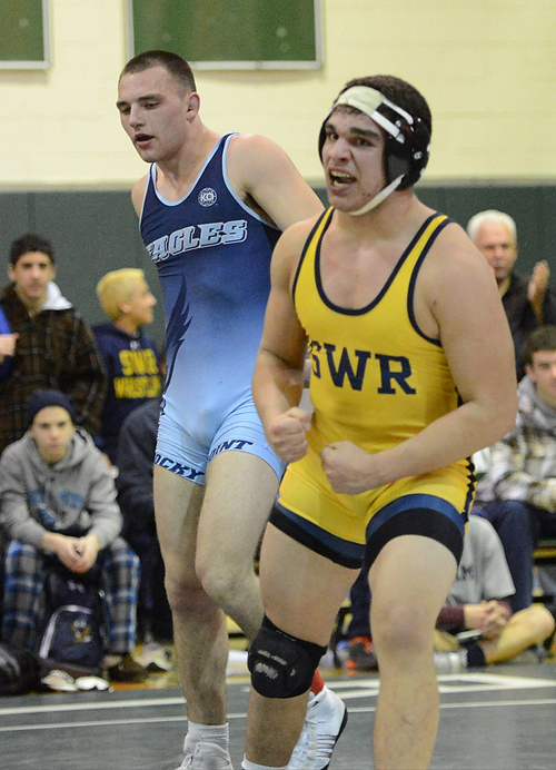 ROBERT O'ROURK PHOTO | Dom Pirraglia of Shoreham-Wading River exulted after his 8-7 triumph over Rocky Point's Zeki Yazak in the 182-pound final.