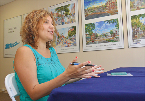 Siris Barrios, community liaison for Renaissance Downtown Riverside Rediscovered in her office on Peconic Avenue. (Credit: Barbaraellen Koch)