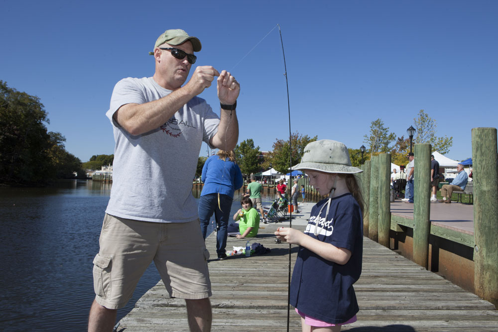 Tom Hubbard of Wading River baits a hook for daughter Ryann, 7.